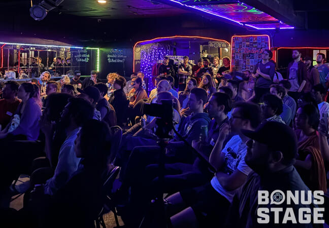 image of attendees watching talks at bonus stage